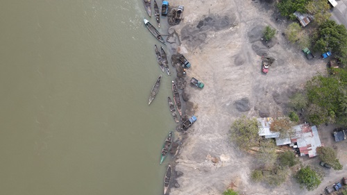 Fotografía con dron en la que aprecia una vista cenital de varias embarcaciones menores extrayendo arena del río Córdoba